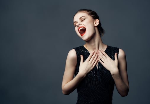 Energetic woman in black dress gestures with hands emotions model surprise delight photo