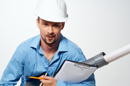 an engineer in a white helmet drawings documents professionals work photo