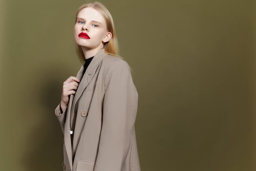 fashionable woman with red lips holds hand near face Lifestyle posing photo