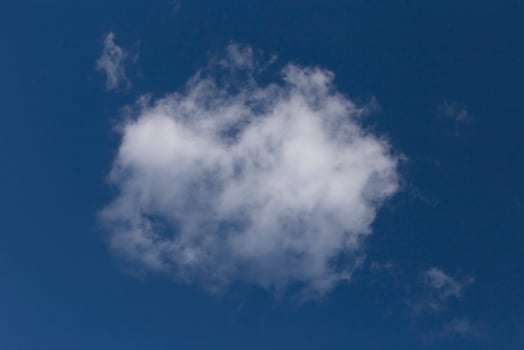 white cloud in a clear blue sky photo