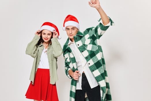 Happy man and woman in Christmas hats portrait cropped view photo
