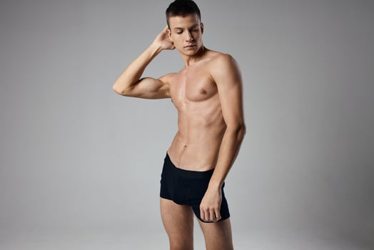 naked guy in black silk holds his hand behind his head sports fitness photo