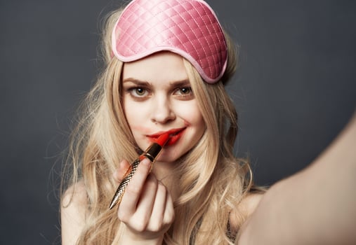 sexy blonde woman with red lipstick emotions and pink mask on her face photo