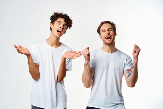 two funny friends in white t-shirts laughing positive emotions photo