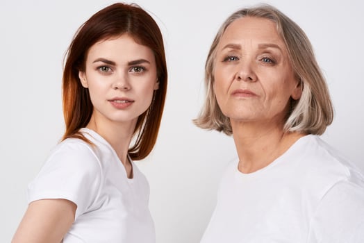 granddaughter and grandmother are standing next to family love studio photo