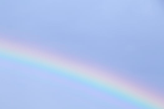 close up of rainbow in a blue sky photo