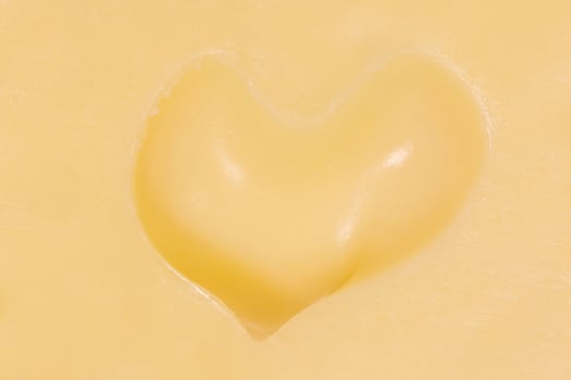 hole in shape of heart in maasdam cheese photo