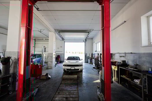 Muscle car at service repair station in lift. photo