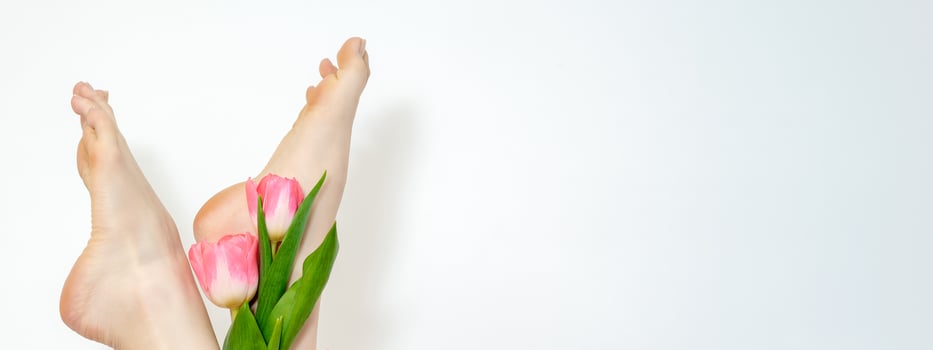 Woman's legs with tulips flowers photo