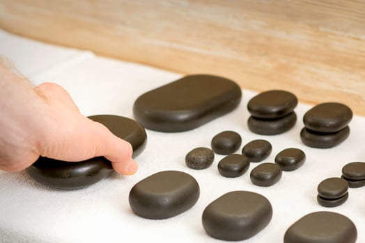 Masseur is taking massage stones photo