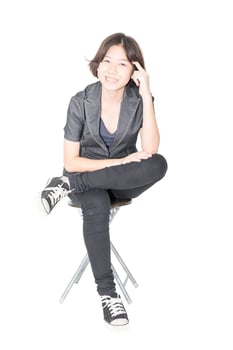 Young women sit on chair over white photo
