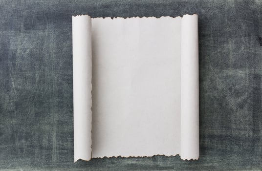 Old paper scroll on a blackbroad photo
