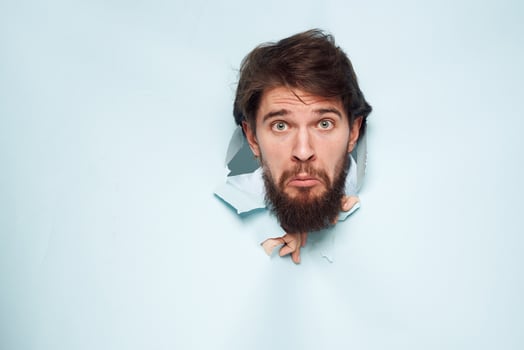screaming bearded man peeking out from behind the wall emotions work photo