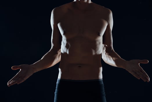 sports man with pumped up abs workout motivation dark background photo