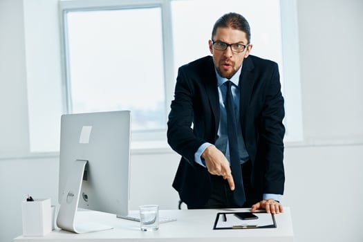 businessman in the office gestures with his hands computer photo