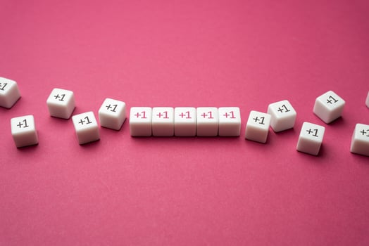 Growing row of blocks plus one. Get support, more help. Sequential addition to the sum. Increase and growth. Accumulation process. Continuation. Strengthening and growth in numbers. Joint efforts. photo