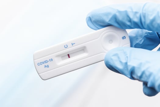 Doctor holding a negative result for COVID-19 with test kit for viral disease. photo