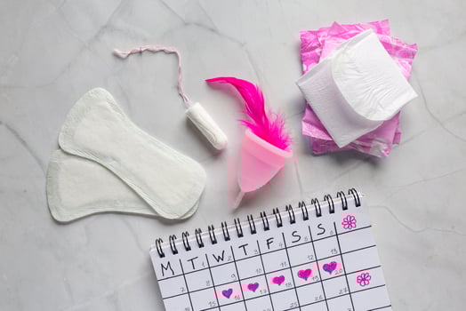 Menstruation calendar with cotton tampons. Woman hygiene protection. Woman critical days. Set of women's means personal hygiene, feminine hygiene pads, cup, menstruation photo