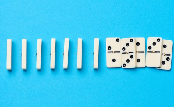 A stack of dominoes on a blue background, an intellectual game photo