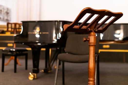 Music stand for paper sheets of music and piano. Before concert in cathedral. Heavy wooden music stand. photo