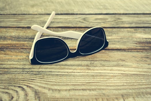 Sunglasses on wooden background. Toned image. photo