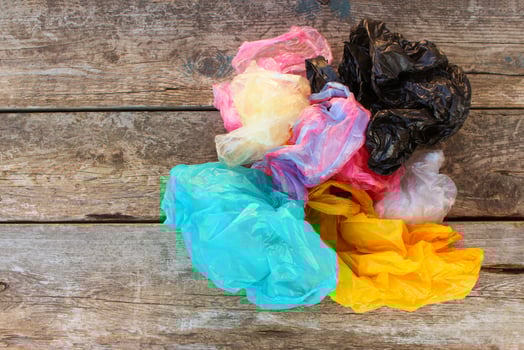 Different plastic bags on old wooden background. Top view. photo