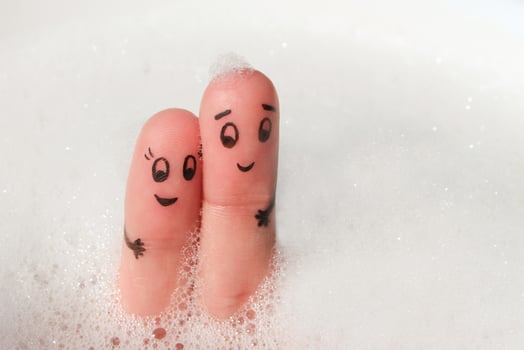Finger art of Happy couple bathe in bath with foam. photo