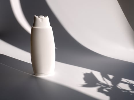 White empty container for cosmetics, shampoo, gel, body care products on a background with shadow. Layout for designer photo