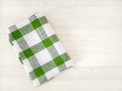 A pile of neatly folded towels on wooden background. Production of natural textile fibers.Organic product. Natural cloth photo