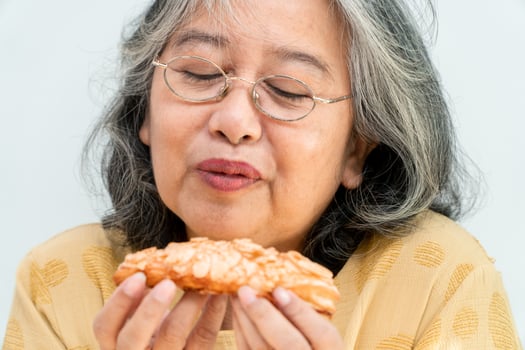 Happy Asian senior women enjoying eating pie photo