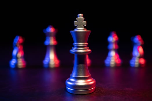 Golden King chess standing in front of other chess, Concept of a leader must have courage and challenge in the competition, leadership and business vision for a win in business games photo