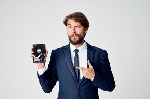 business man in suit hard drive information data recovery photo