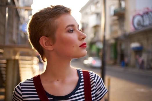 short haired woman wearing glasses outdoors walking posing photo