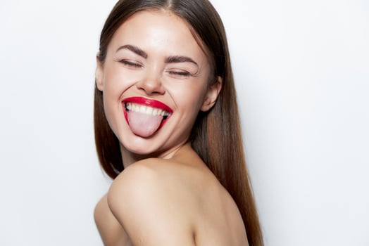 Attractive woman Bare shoulders shows tongue closed eyes smile spa treatments photo