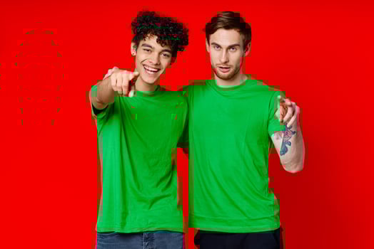 Two cheerful friends hug green t-shirts emotions photo