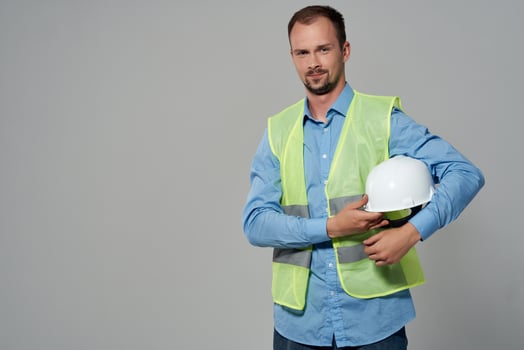 man in white helmet blueprints builder light background photo