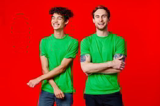 two friends green t-shirts communication lifestyle red background photo