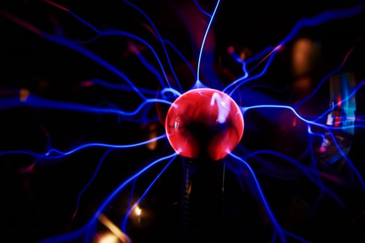 Plasma ball with energy rays on dark background photo