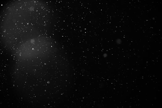 Falling snow flakes or rain on black background photo