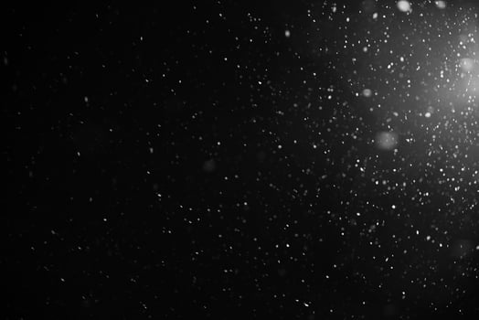 Falling snow flakes or rain on black background photo