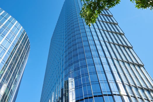 Modern city architecture, Skyscraper glass facade with green tree photo