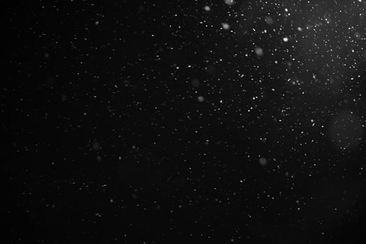 Falling snow flakes or rain on black background photo