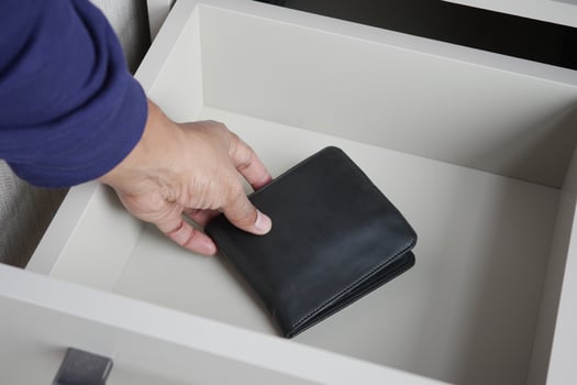 men stealing wallet from a drawer photo