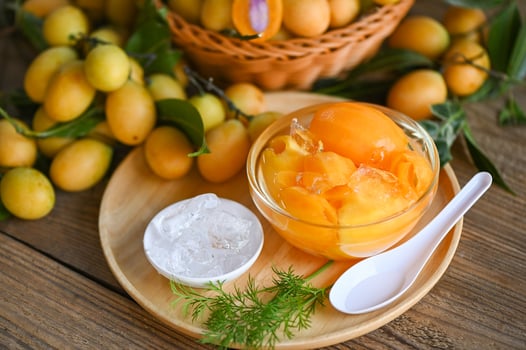 Sweet dessert marian plum fruit  on bowl for food and wooden background, tropical fruit Name in Thailand sweet Yellow Marian Plum Maprang Plango or Mayong chid photo