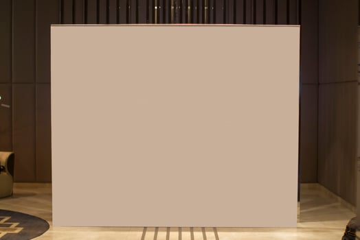 A blank white advertising banner stands in the lobby of the room. photo