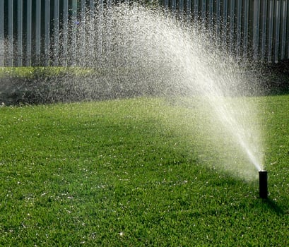 Automatic garden irrigation system watering lawn. Savings of water from sprinkler irrigation system with adjustable head. Automatic equipment for irrigation and maintenance of lawns, gardening. photo