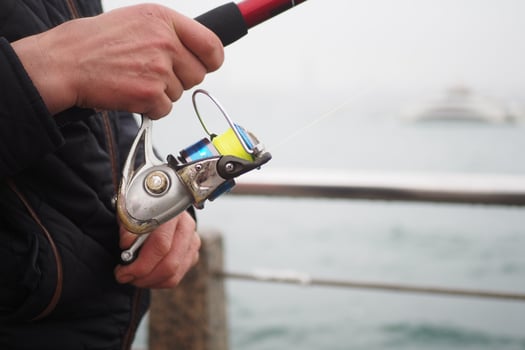 Fisherman with rod, spinning reel , photo