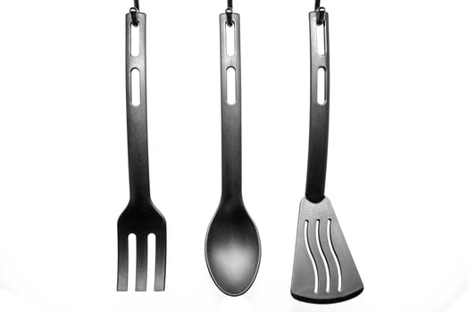 black kitchen utensils on white background photo