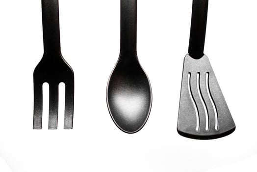 black kitchen utensils on white background photo