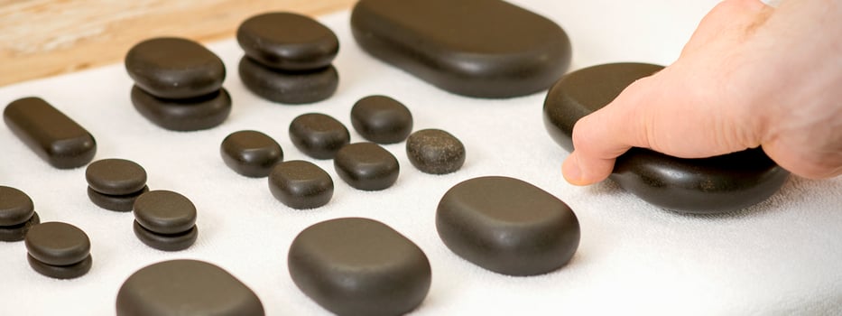 Masseur is taking massage stones photo